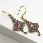 Pair of 9ct yellow gold and silver flared earrings set with rubies and diamonds