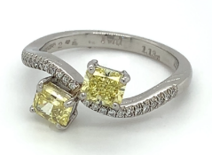 1.25ct total weight natural fancy intense yellow diamond ring set in platinum. GIA certified