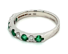 Natural green emerald and diamond eternity ring in 18kt white gold. 0.73ct total weight