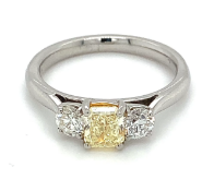 1.18ct total weight trilogy ring. Natural fancy yellow diamond set in platinum. GIA certified