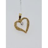 18ct yellow gold heart-shaped pendant set with a single diamond