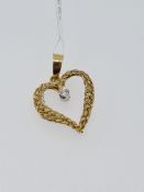 18ct yellow gold heart-shaped pendant set with a single diamond