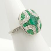 A stylish emerald and diamond Art Deco-styled panel ring in platinum