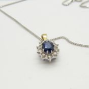 An 18ct yellow and white gold sapphire and diamond cluster pendant on a silver chain, boxed