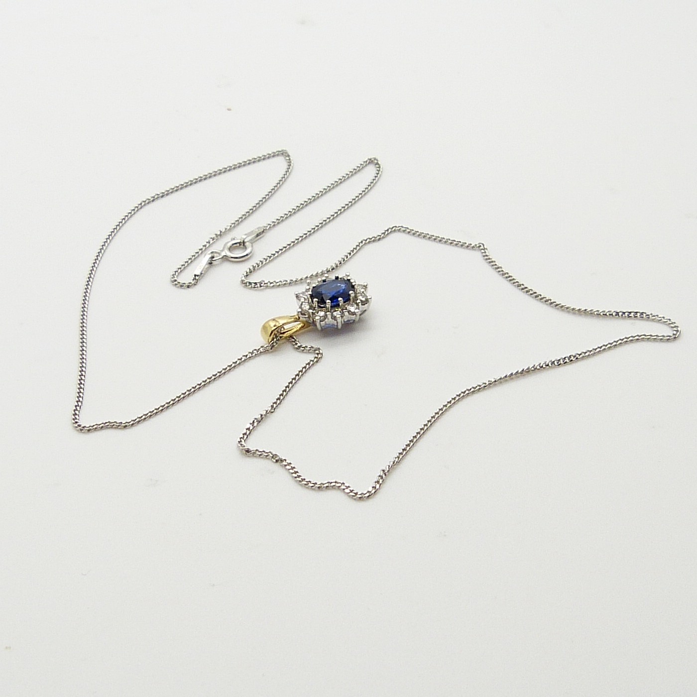 An 18ct yellow and white gold sapphire and diamond cluster pendant on a silver chain, boxed - Image 7 of 7