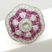 A platinum floral-styled 1.75 carat diamond and 1.45 carat ruby cocktail ring