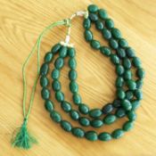 A large and weighty 3-strand natural earth-mined carved 2,100.00 ct emerald necklace