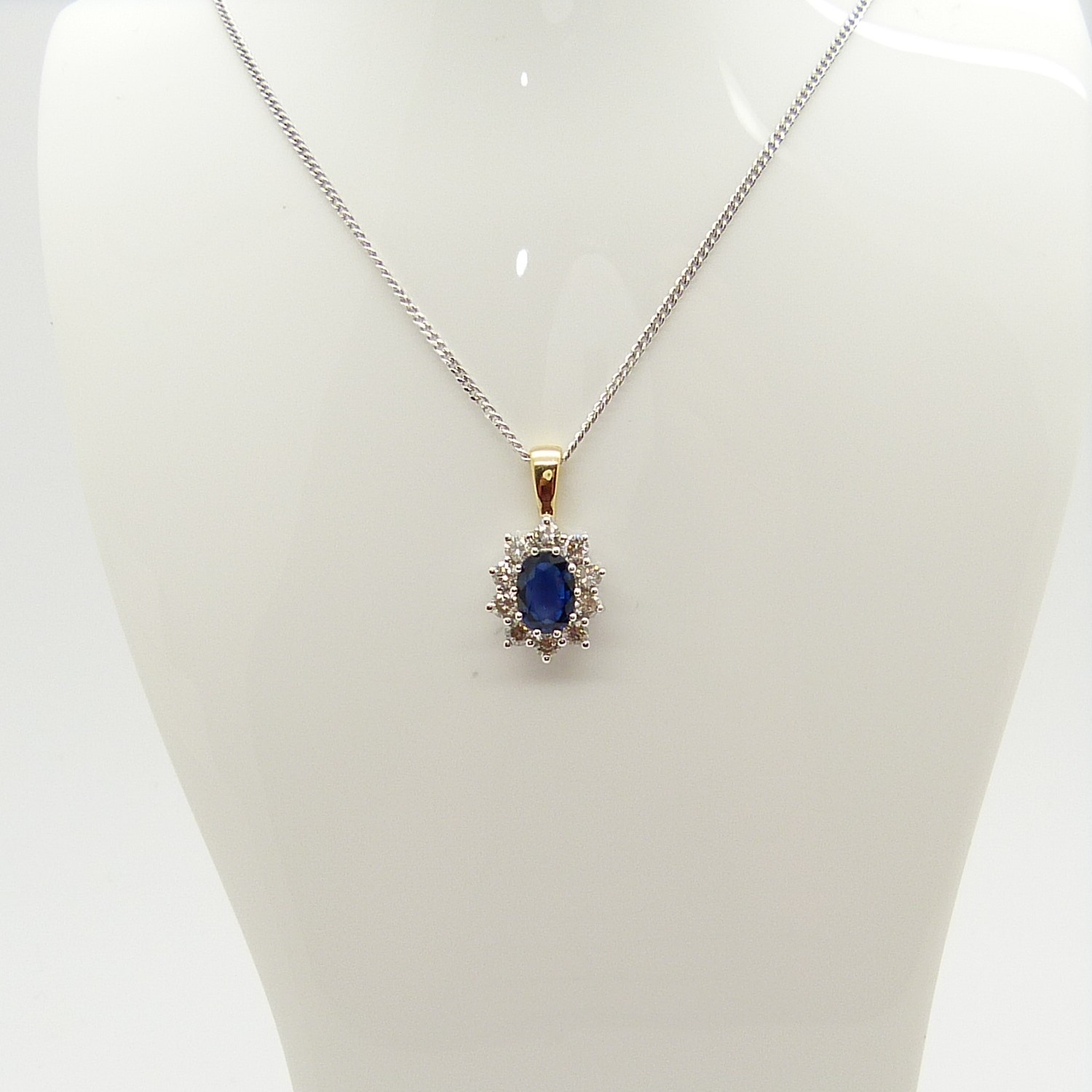 An 18ct yellow and white gold sapphire and diamond cluster pendant on a silver chain, boxed - Image 5 of 7