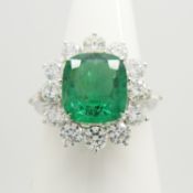 An 18ct white gold cushion-cut 1.76 carat emerald and 1.10 carat diamond cluster ring