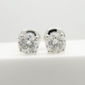 A certificated pair of 18ct white gold, 1.26 carat, round brilliant-cut diamond studs