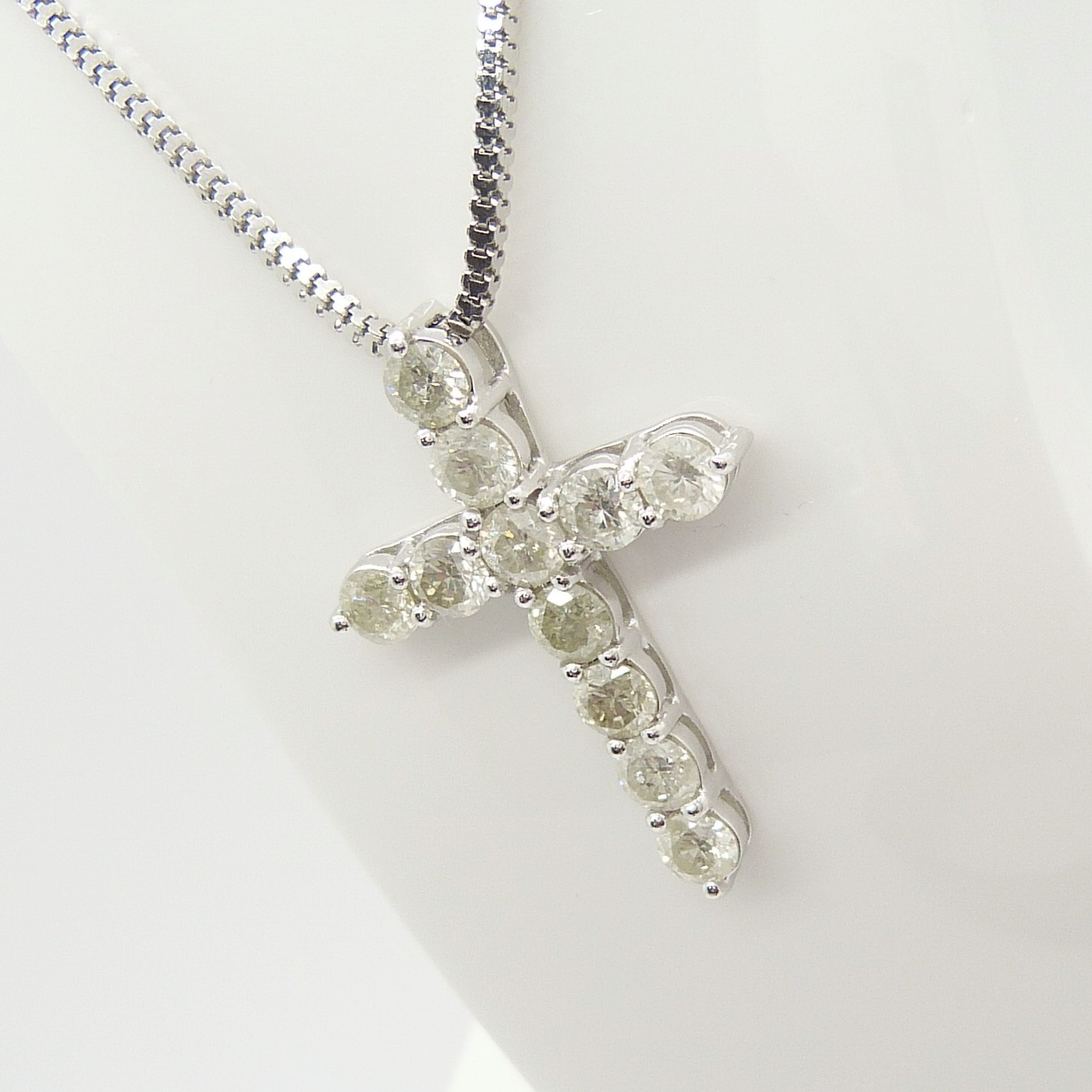 A 14ct white gold diamond cross pendant on a silver snake link chain, boxed - Image 4 of 6