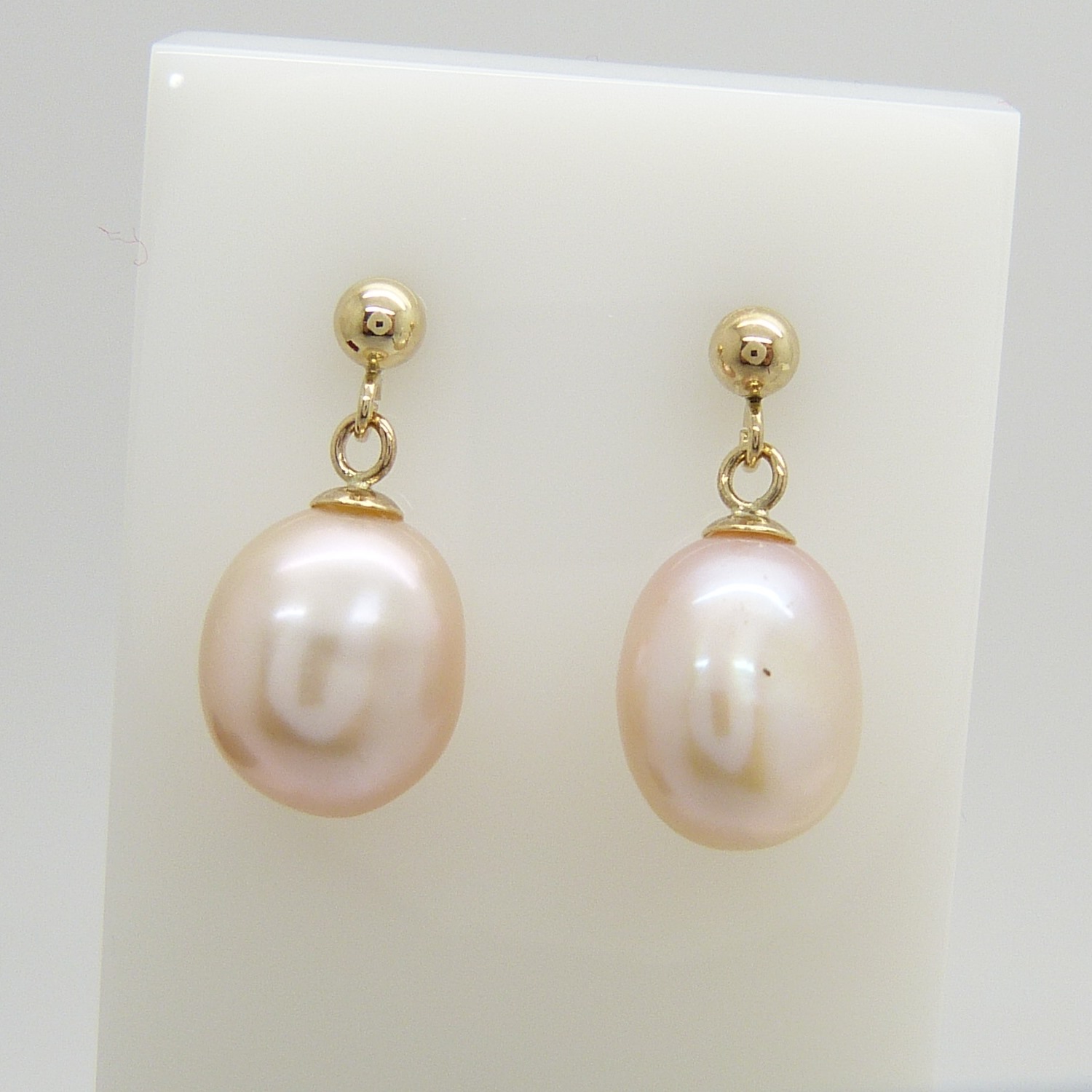 A pair of white freshwater pearl drop ear studs in 9ct yellow gold, boxed