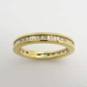 An 18ct yellow gold full eternity ring set with 0.50 carats of tapered baguette diamonds, certified
