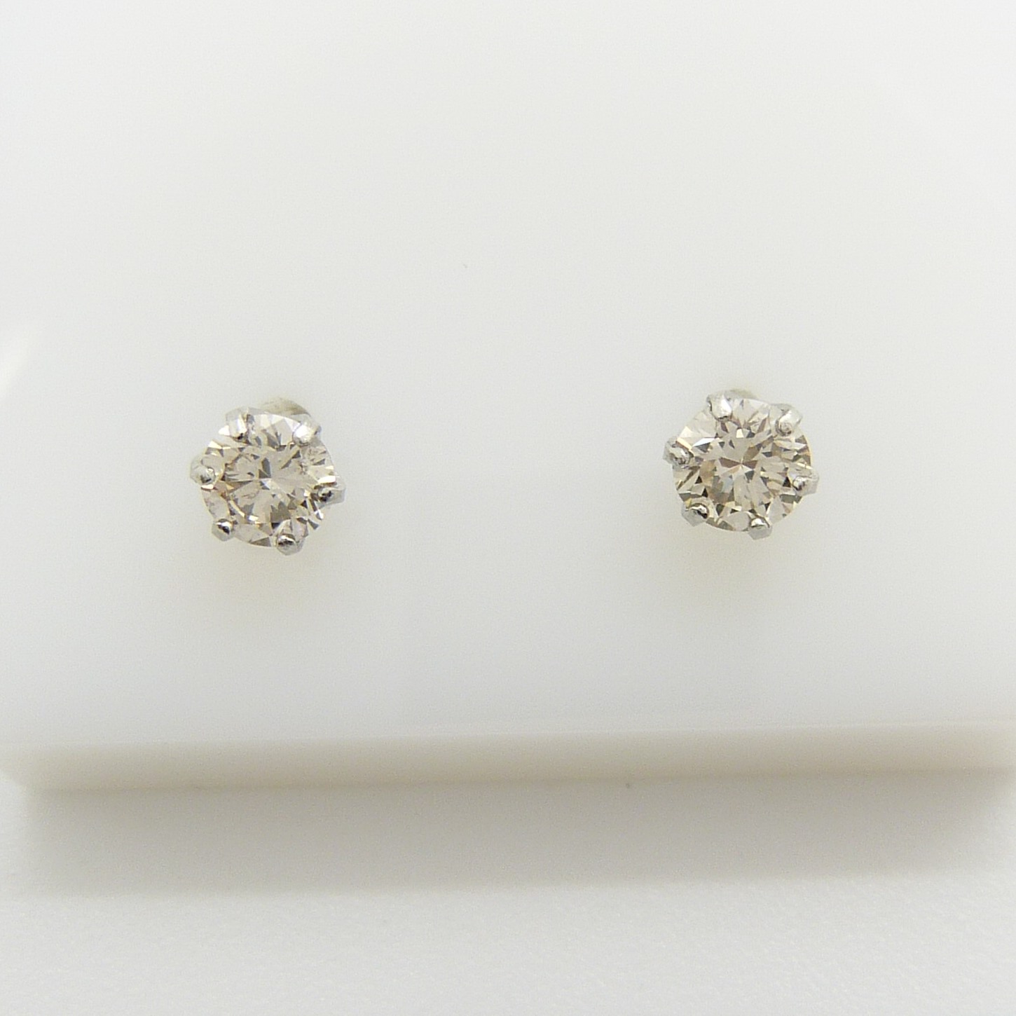 A pair of platinum 0.30 carat round brilliant-cut diamond solitaire ear studs, boxed