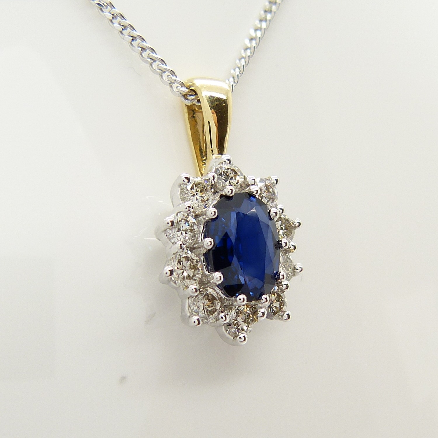 An 18ct yellow and white gold sapphire and diamond cluster pendant on a silver chain, boxed - Image 6 of 7