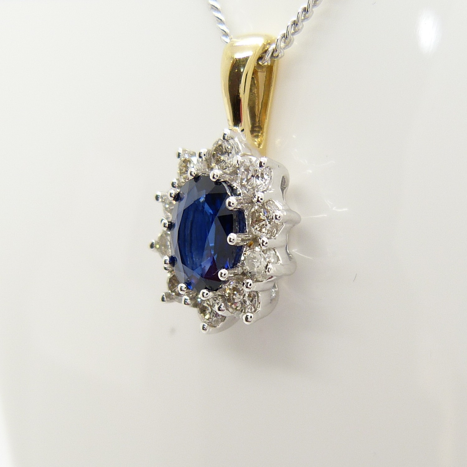 An 18ct yellow and white gold sapphire and diamond cluster pendant on a silver chain, boxed - Image 2 of 7