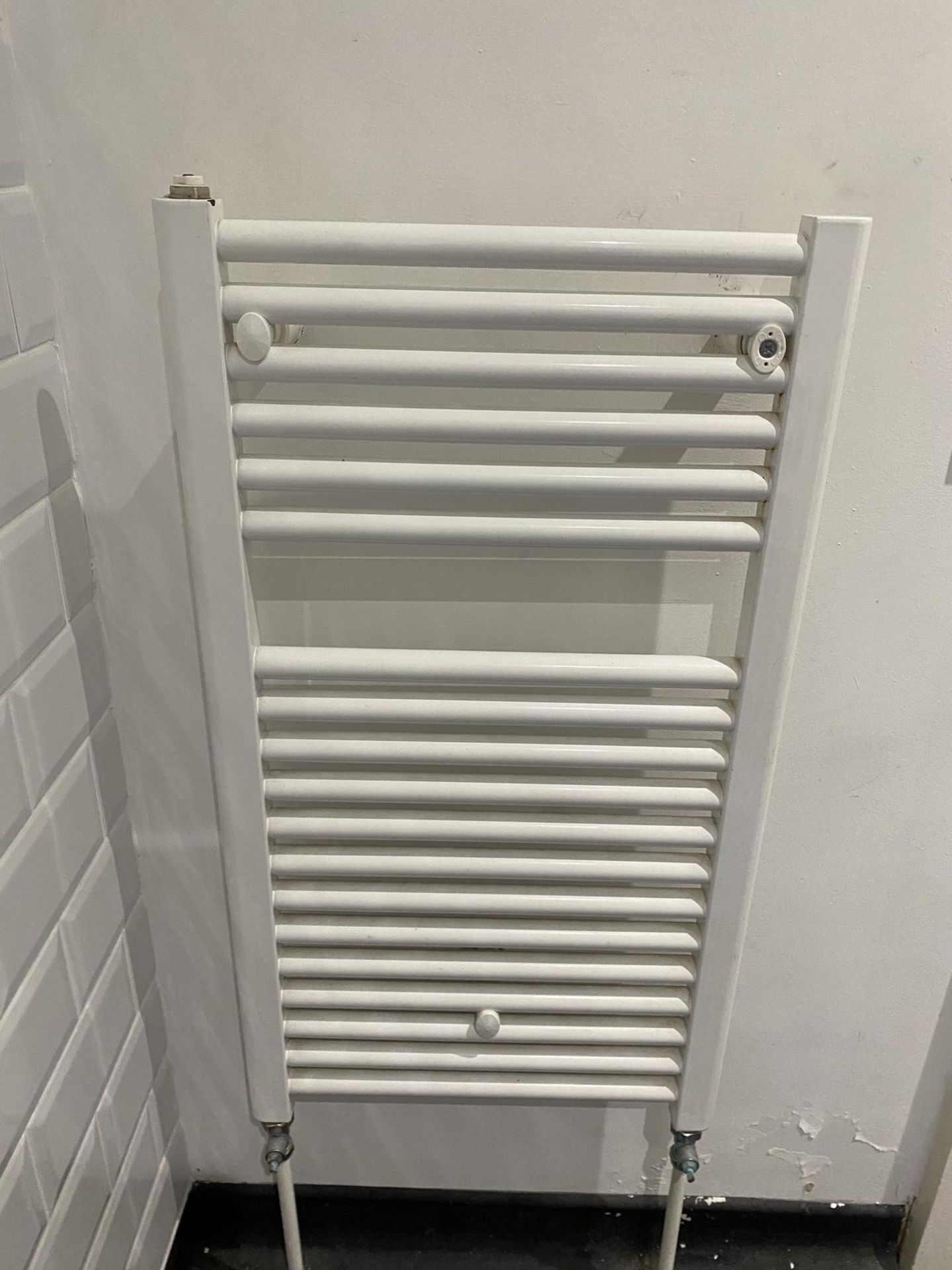 Bathroom white towel heater radiator.