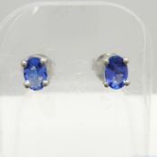 A pair of oval-cut natural tanzanite and silver ear studs