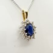 An 18ct yellow and white gold sapphire and diamond cluster pendant on a silver chain, boxed