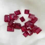 A parcel of 18 unmounted, unspecified red stones in various cuts, totalling 95.60 carats