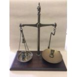 Brass weighing scales on wooden base