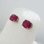 A pair of oval-cut 1.70ct treated ruby gemstone stud earrings, boxed