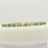 A stunning 9.35 carat emerald and 1.00 carat diamond line bracelet in 18ct yellow gold, certificated