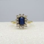 A 9ct yellow gold rectangular treated 0.85 carat sapphire and diamond cluster ring