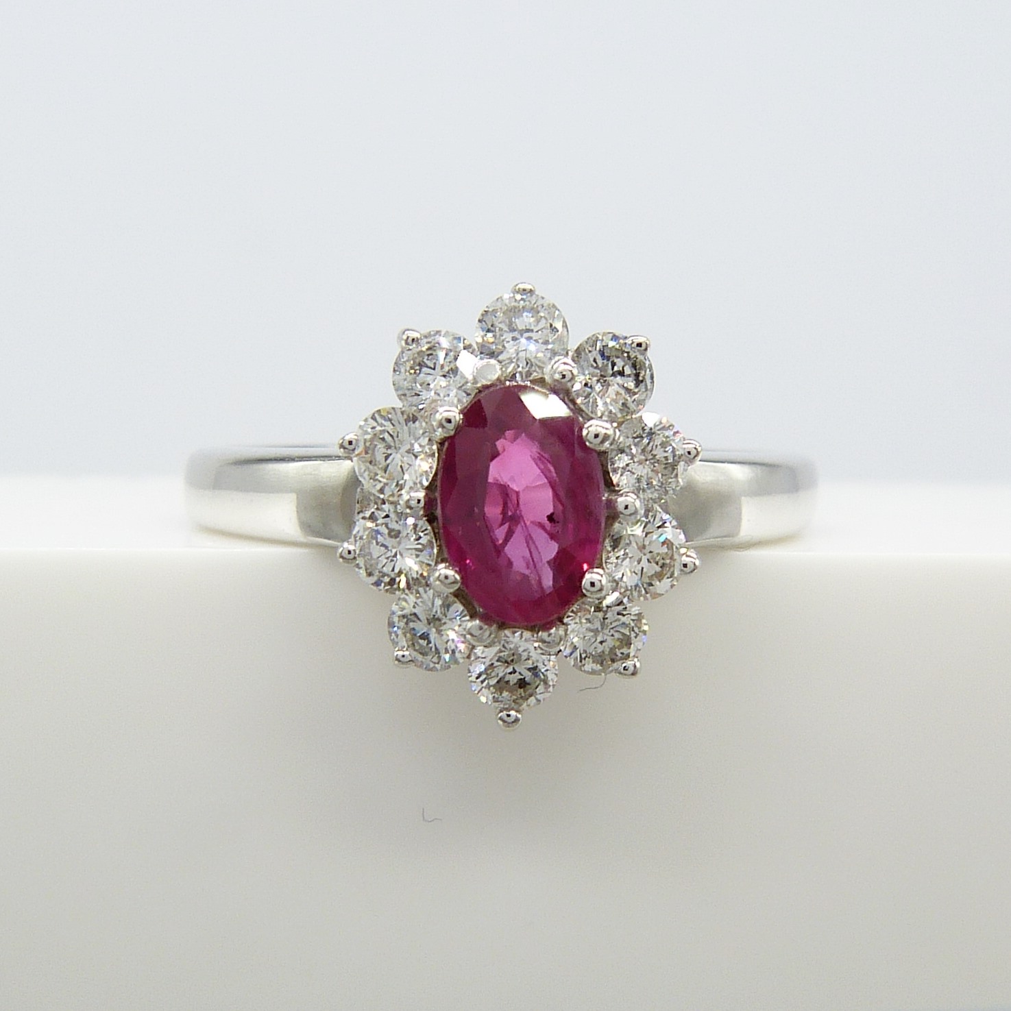 A ruby and diamond (F-G colour) cluster ring in 18ct white gold, with certificate