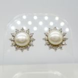 A pair of 9ct white gold cultured pearl and diamond halo stud earrings, boxed