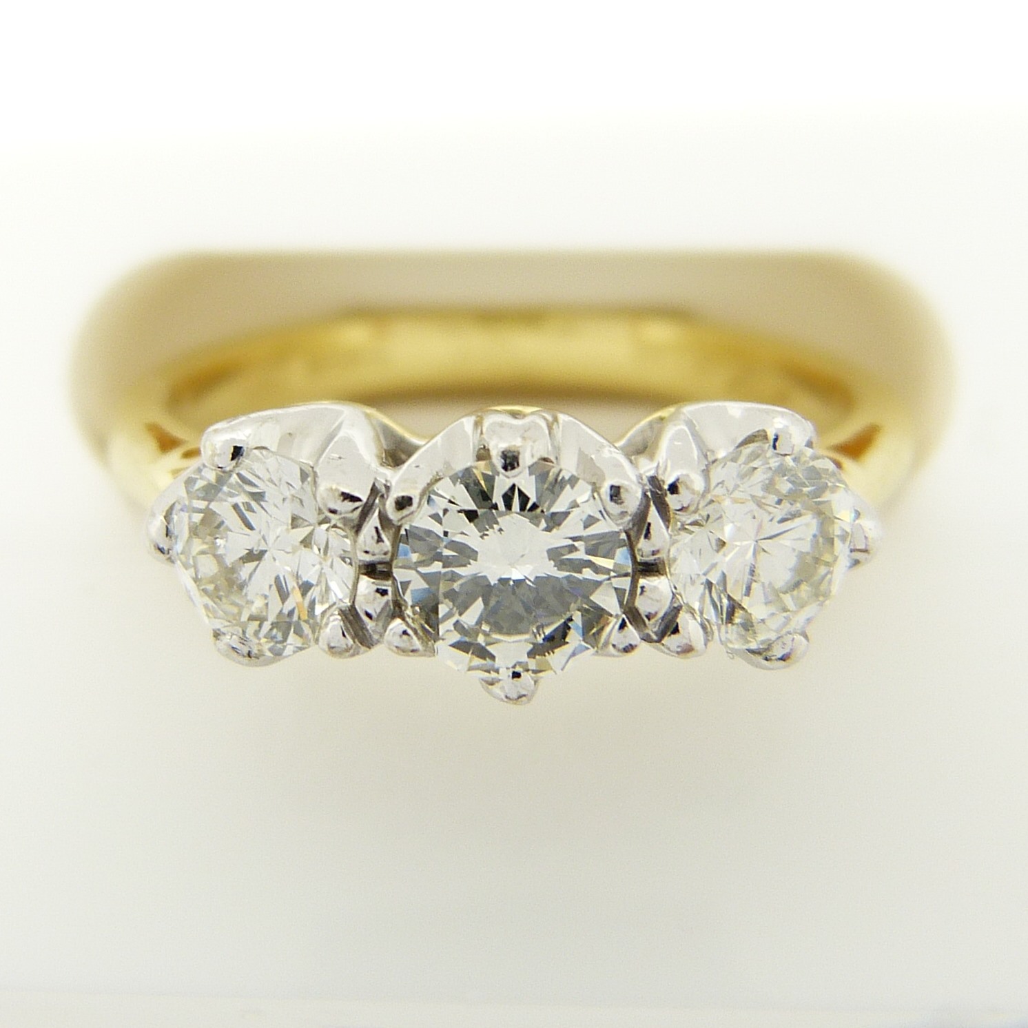 A certificated 0.95 carat diamond trilogy ring in 18ct white and yellow gold