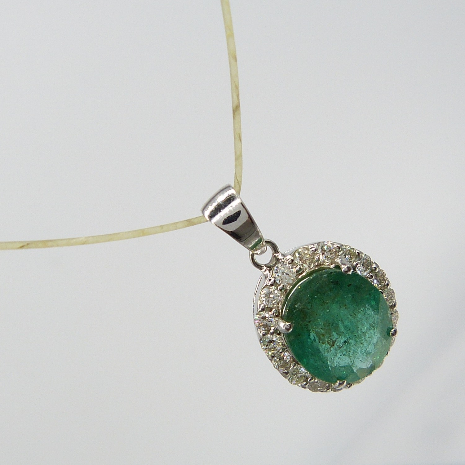 A large emerald and diamond halo pendant in 18ct white gold - Image 3 of 7