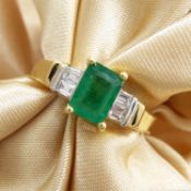 An 18ct yellow gold emerald-cut emerald ring set with baguette-cut diamond shoulders