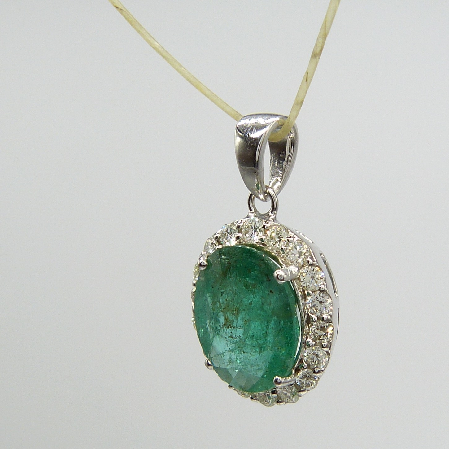 A large emerald and diamond halo pendant in 18ct white gold - Image 5 of 7