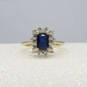 A 9ct yellow gold rectangular treated 0.85 carat sapphire and diamond cluster ring