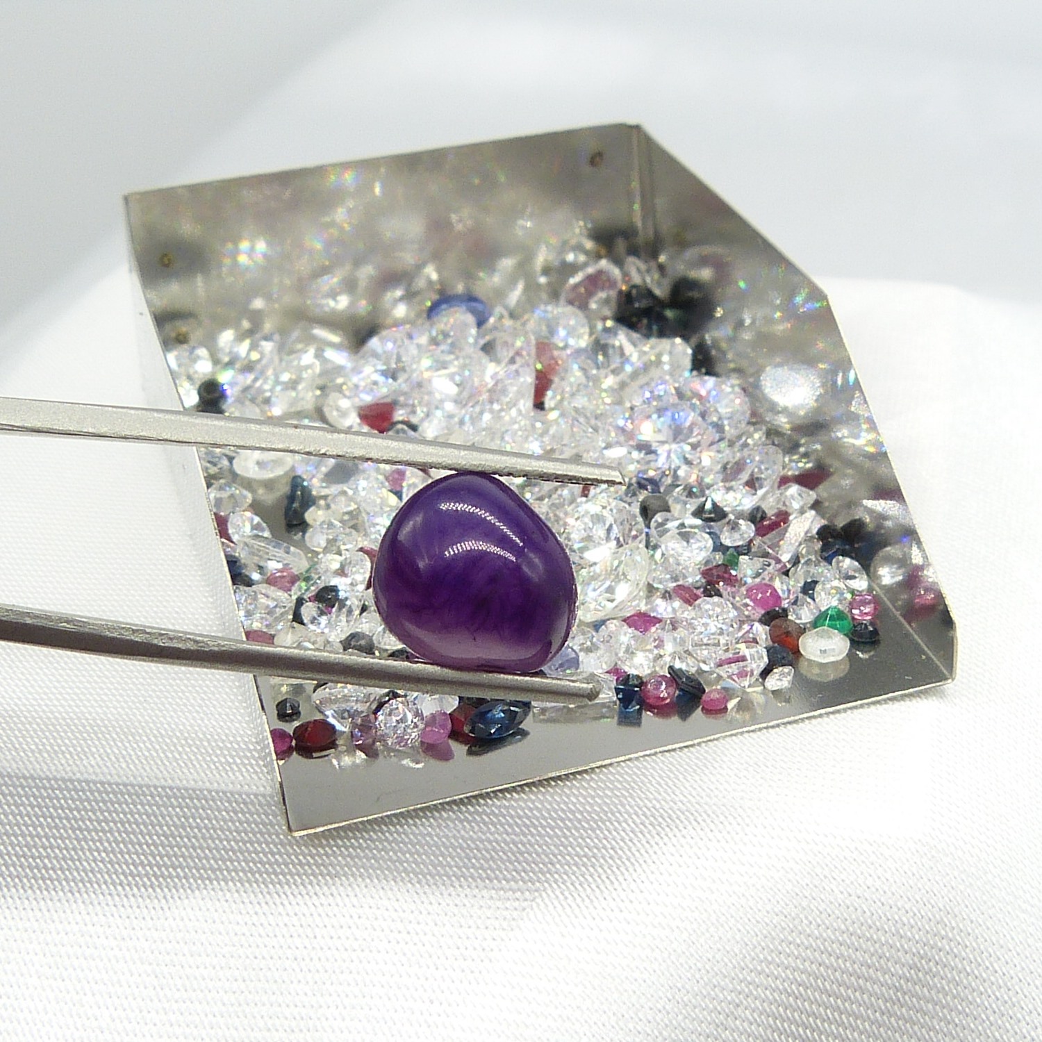 A parcel of loose stones incl. tumbled Amethyst, Garnet, Sapphire and Cubic Zirconia. 104.05 carats