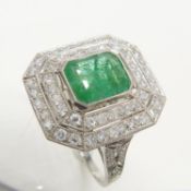 A superb, octagonal Platinum 1.85 carat Emerald and 1.20 carat double-Diamond halo ring