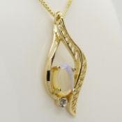 A 9ct yellow gold white opal and diamond filigree pendant and chain