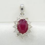 An 18ct white gold oval ruby and round brilliant-cut diamond cluster pendant
