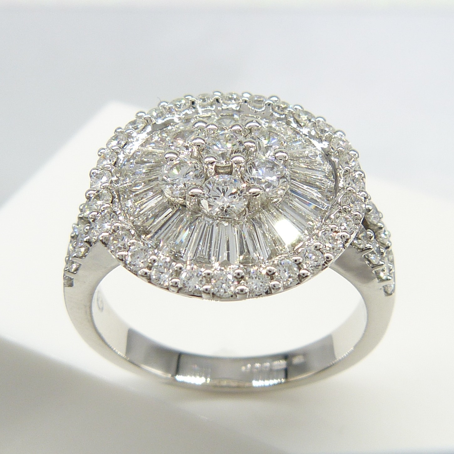 An attractive, certificated, 2.05 carat Diamond cluster ring in 18k white Gold, with Diamond