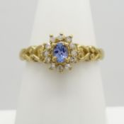 A 9ct yellow Gold Tanzanite and Diamond dress ring with heart design shoulders