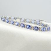 An 8.91 carat tanzanite and diamond line bracelet in 18ct white gold, boxed