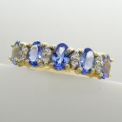 A tanzanite and alternate-set white sapphire dress ring in 9ct yellow gold