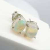 A pair of Silver ear studs set with oval Cabochon white Opal gemstones