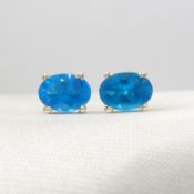 A pair of Silver ear studs set with oval-cut blue apatite gemstones