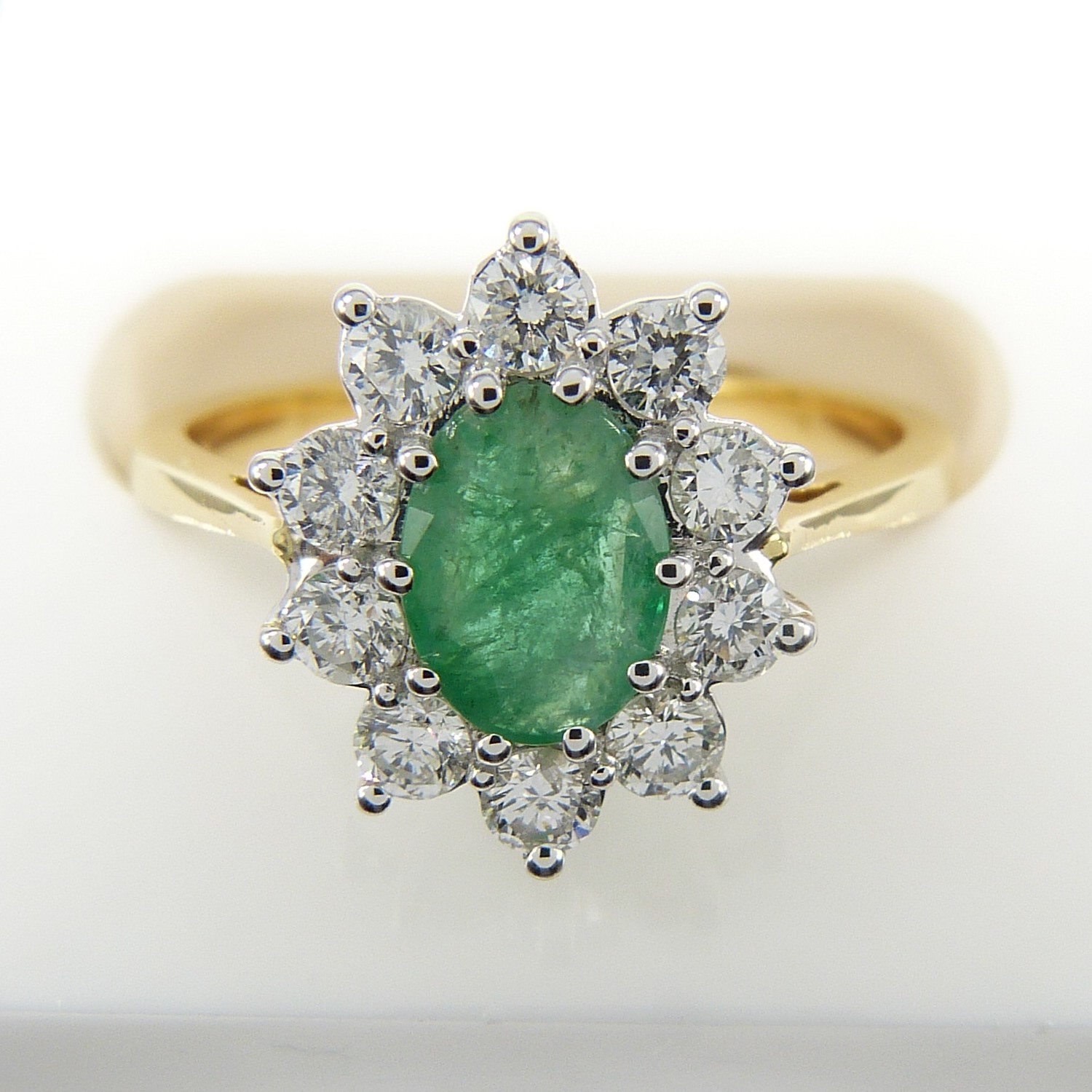 A certificated 18ct yellow Gold oval Emerald gemstone and round brilliant-cut Diamond ring