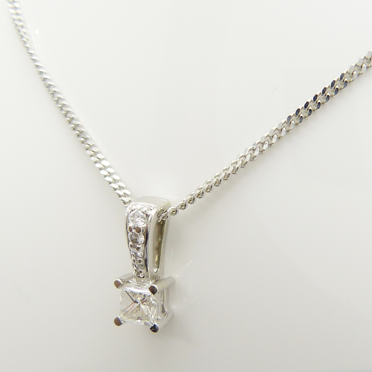 A pre-owned 0.30 carat princess-cut solitaire diamond pendant and chain, boxed