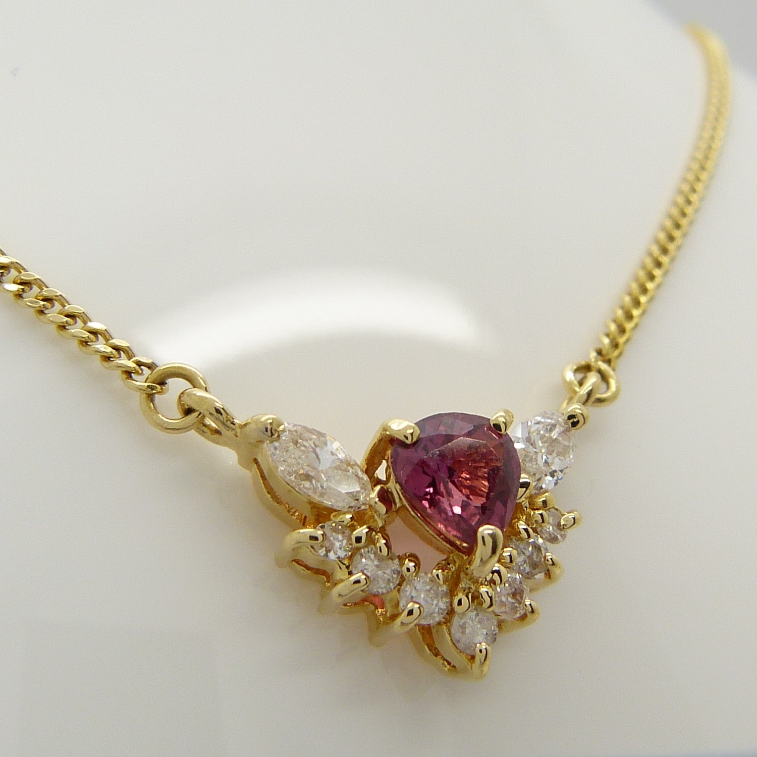 A stylish ruby and marquise diamond necklace in 18ct yellow gold, boxed