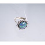 Damenring 585 WG, besetzt m. 1 runder Opal-Scheibe u. 14 Brillanten von zus. ca. 0.70 ct/vvs1/D-E,