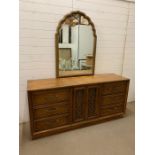 A sideboard with mirror with double door to centre with three drawers either side (H205cm W178cm